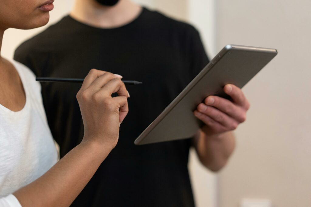 pexels-photo-6969879-6969879 Two colleagues collaborating using a digital tablet and stylus in a modern office environment.